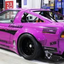 back side of a pink car with some decals on it