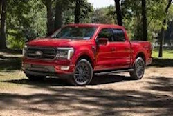 red f-150 with a forest background red f-150 with a forest background